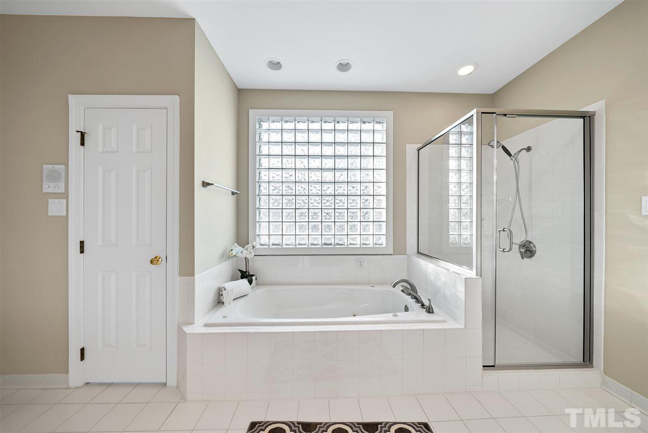 7605 Rainwater Road Raleigh, NC 27615 - Photo 17 of 30 a bathroom with a bathtub and shower
