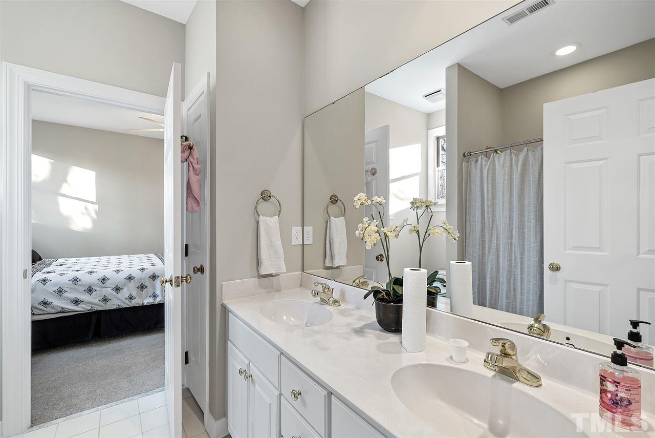 7605 Rainwater Road Raleigh, NC 27615 - Photo 20 of 30 a en suite bathroom with sinks mirror and double
