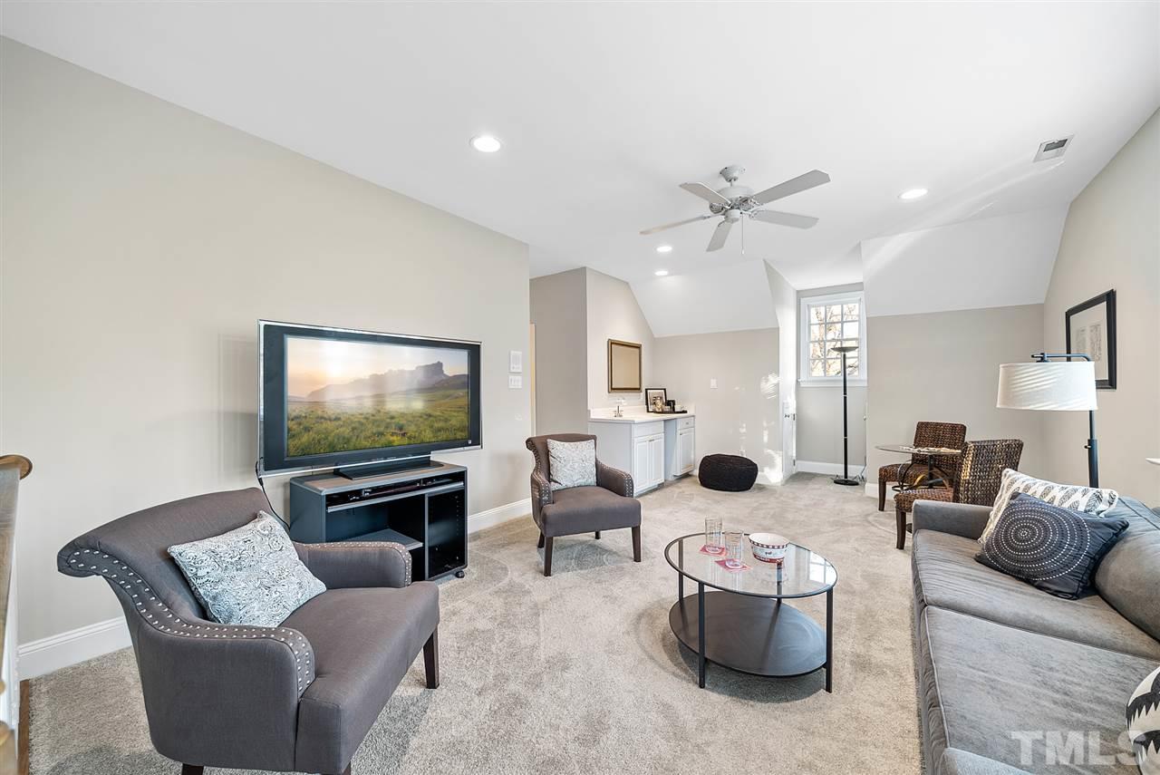 7605 Rainwater Road Raleigh, NC 27615 - Photo 24 of 30 a living room with furniture and a flat screen tv