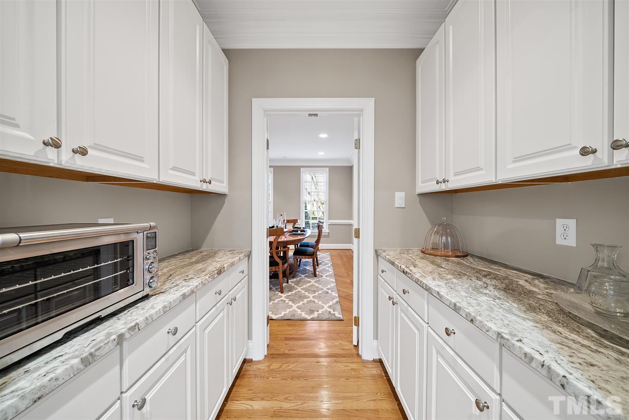 7605 Rainwater Road Raleigh, NC 27615 - Photo 8 of 30 a kitchen with granite countertop a stove and cabinets