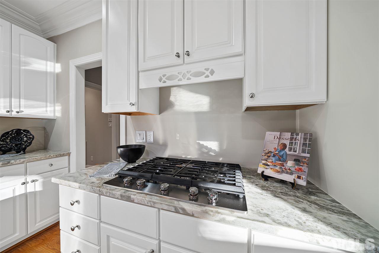 7605 Rainwater Road Raleigh, NC 27615 - Photo 10 of 30 a kitchen with white cabinets and appliances