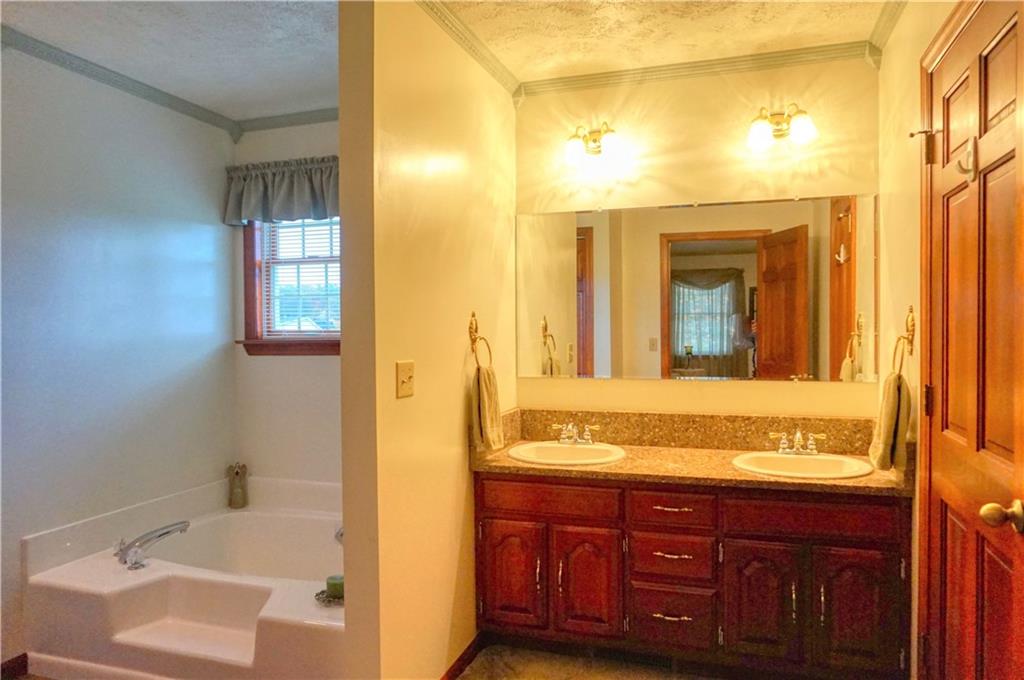 212 Holyoke Road Butler, PA 16001 - Photo 20 of 25 Master bathroom offers double sinks, quartz counter, soaking tub, shower and walk-in closet!