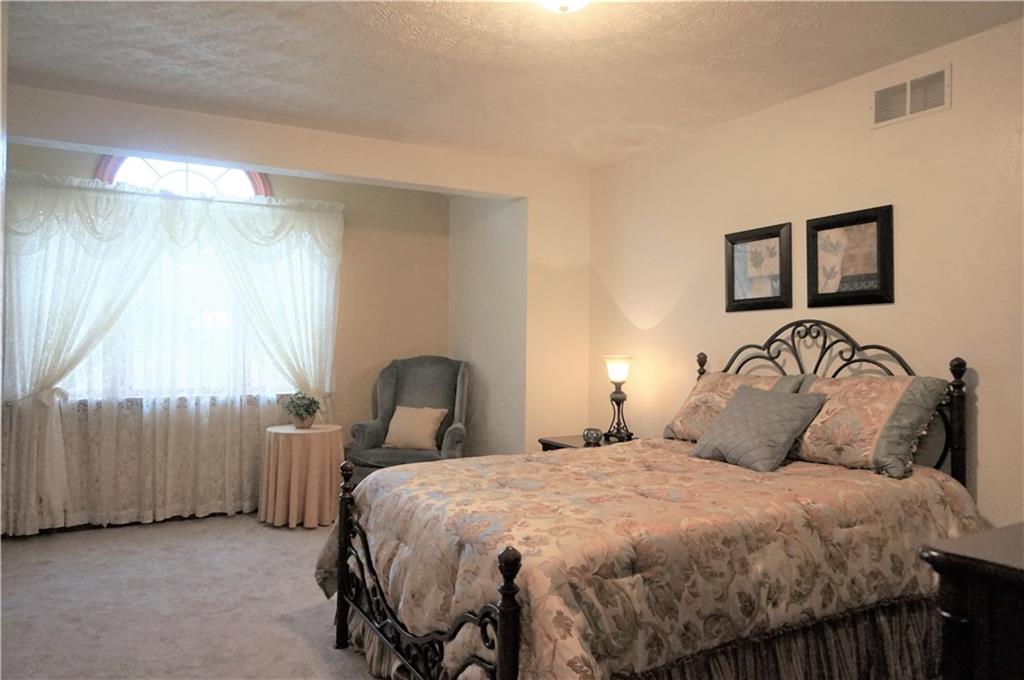 212 Holyoke Road Butler, PA 16001 - Photo 22 of 25 Second bedroom with vaulted ceiling, arched window and brand new carpet!