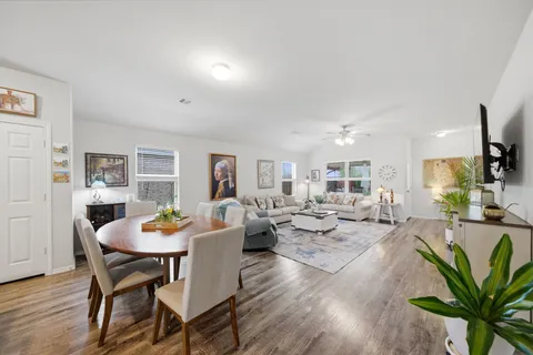 a room with stainless steel appliances lots of counter top space and furniture