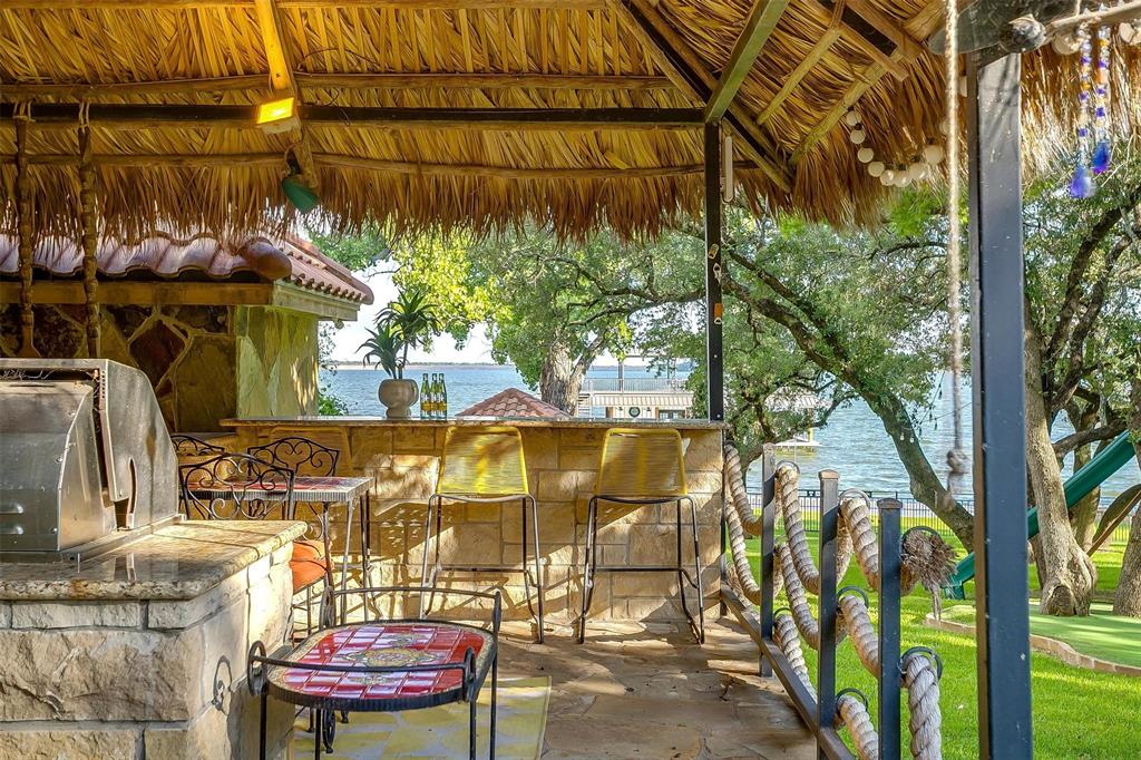 9930 Boat Club Road Fort Worth, TX 76179 - Photo 39 of 40 This outdoor palapa located by the pool at the primary residence includes a grill, bar, and space for hosting.