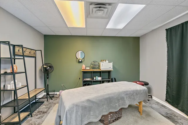 a bed sitting in a bedroom next to a window