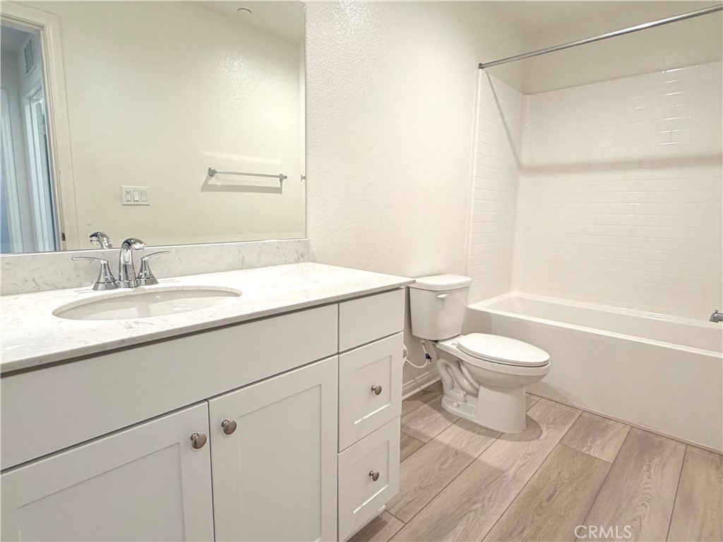 7631 Rubyred Gln Drive Riverside, CA 92507 - Photo 16 of 17 a bathroom with a sink a toilet and a bathtub