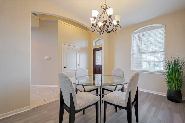 a dining room with furniture and chandelier