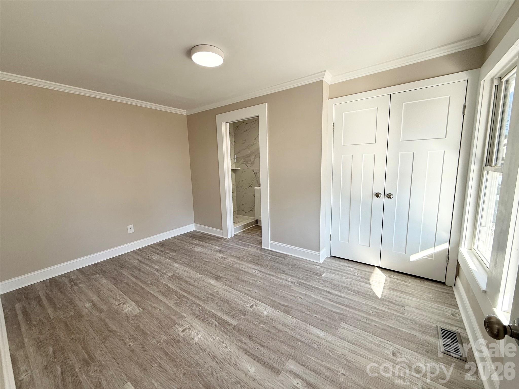 438 Pop Davis Road Taylorsville, NC 28681 - Photo 15 of 31 an empty room with wooden floor and window