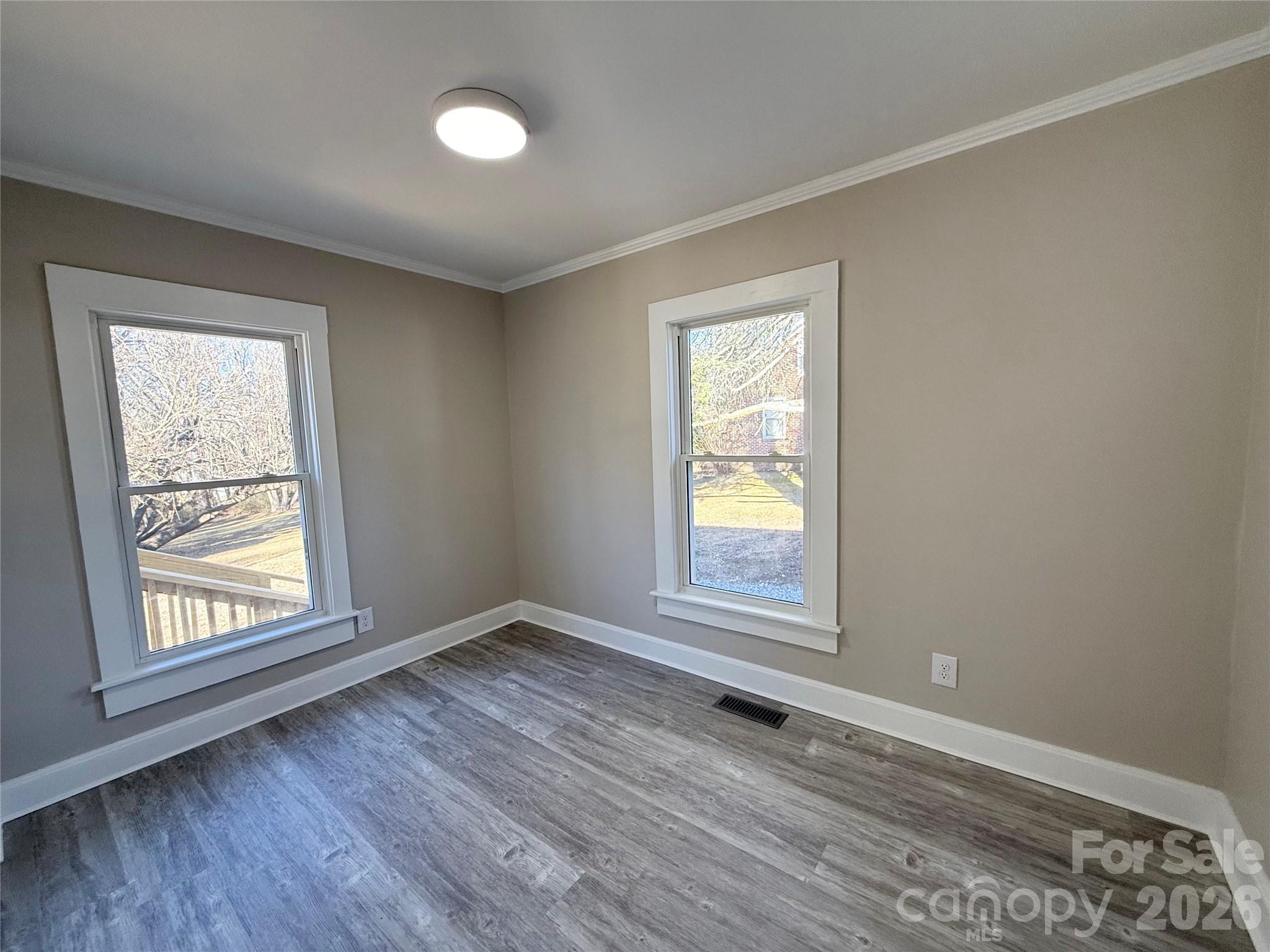 438 Pop Davis Road Taylorsville, NC 28681 - Photo 17 of 31 an empty room with wooden floor and windows