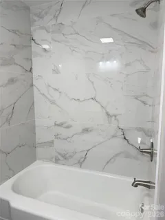 a bathroom with a sink and mirror with toilet