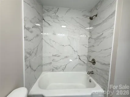 an empty room with wooden floor and entrance