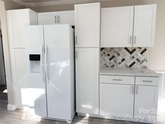 a white refrigerator freezer sitting inside of a kitchen