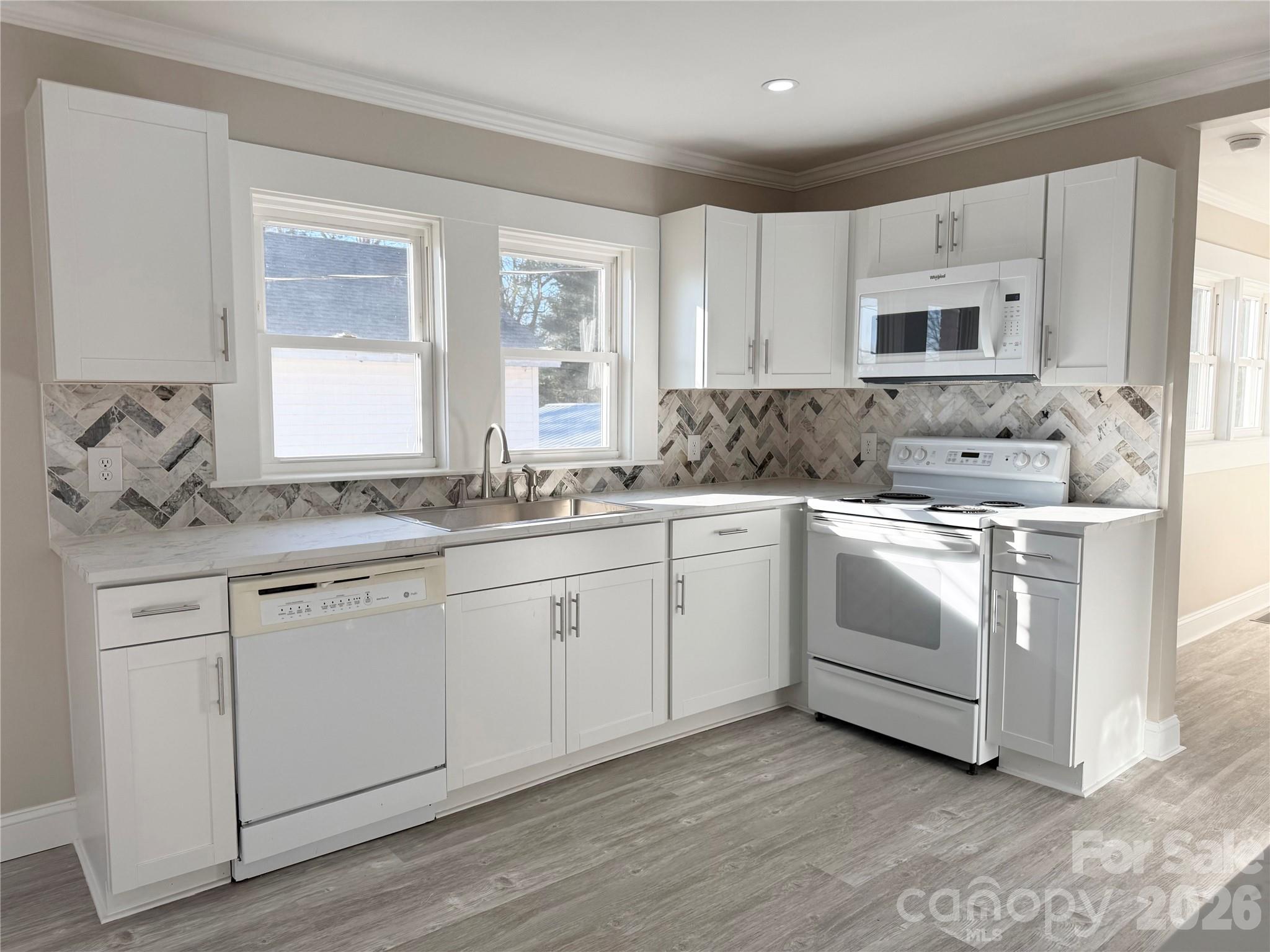 438 Pop Davis Road Taylorsville, NC 28681 - Photo 6 of 31 a view of a sink and dishwasher with wooden floor
