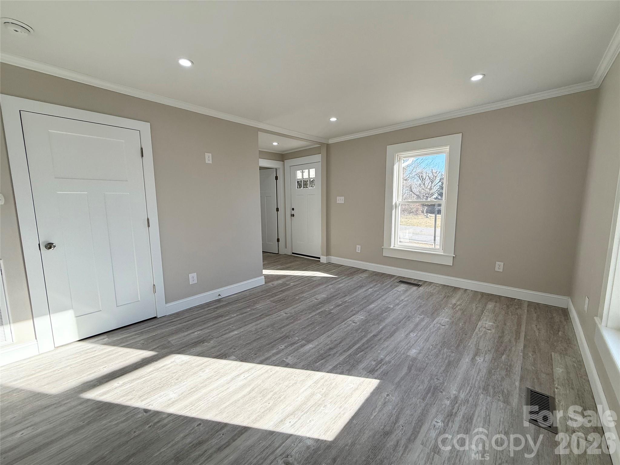 438 Pop Davis Road Taylorsville, NC 28681 - Photo 10 of 31 an empty room with wooden floor and windows