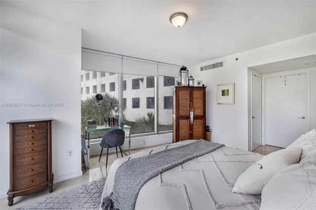 a bedroom with a bed and a night stand