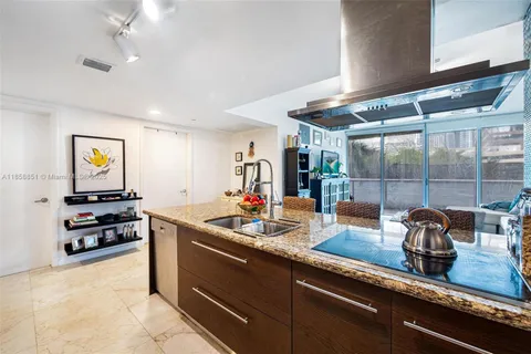 a kitchen with kitchen island a sink stove and refrigerator