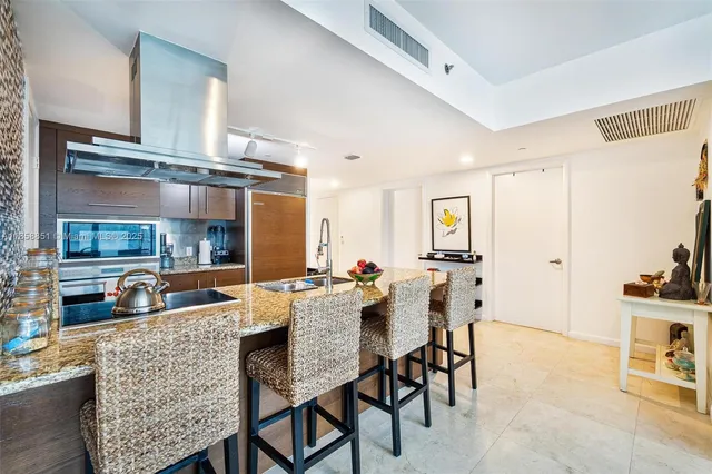 a bathroom with a granite countertop sink toilet a mirror and shower