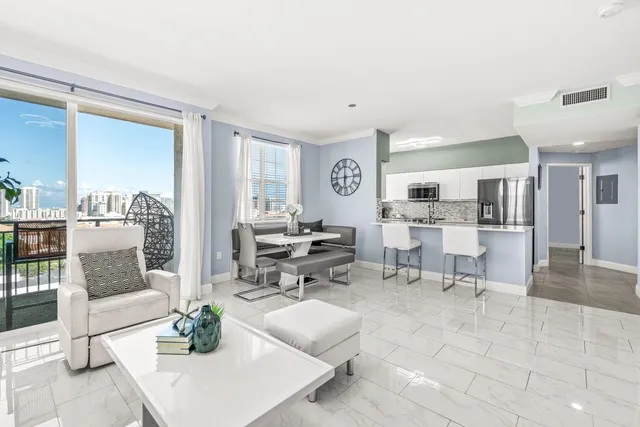 a living room with furniture and view of kitchen