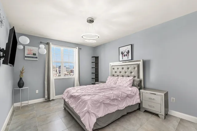 a bedroom with a large bed and a window