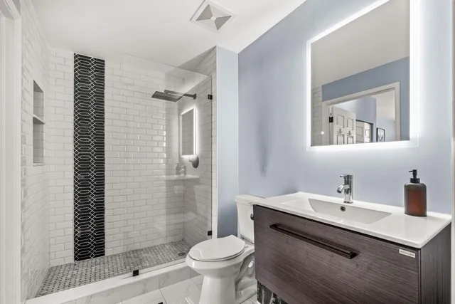 a bathroom with a sink toilet and shower