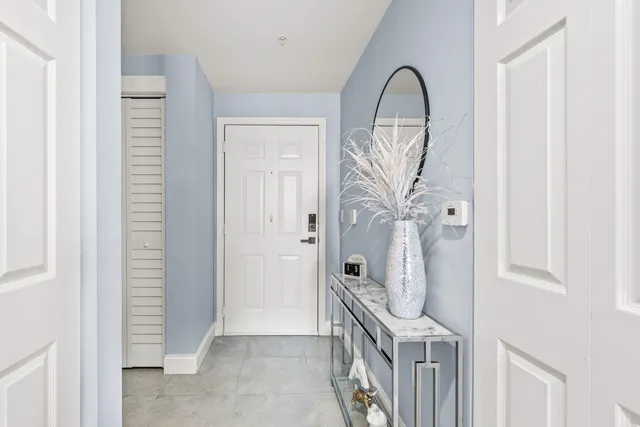 a view of a livingroom with wooden floor and a hallway