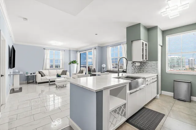 a large white kitchen with a large window