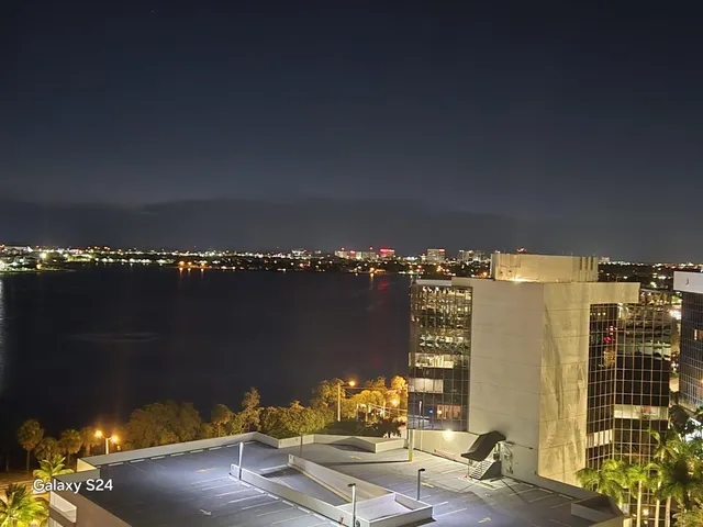 a living room with furniture a large mirror and a chandelier
