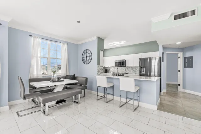 a living room with furniture a dining table and kitchen view