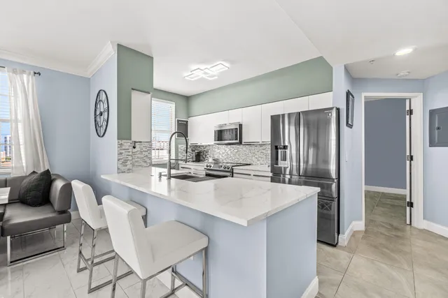 a kitchen with stainless steel appliances a refrigerator and a stove