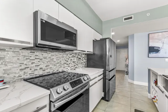 a stove top oven sitting inside of a kitchen