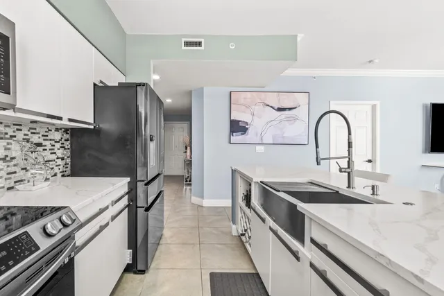 a kitchen with stainless steel appliances granite countertop a sink stove and refrigerator