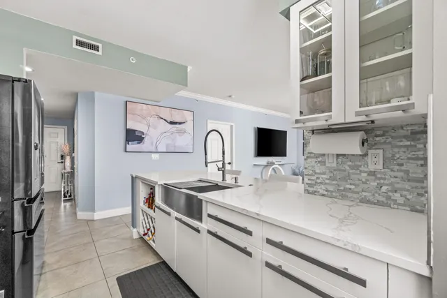 a kitchen with stainless steel appliances a sink stove and refrigerator