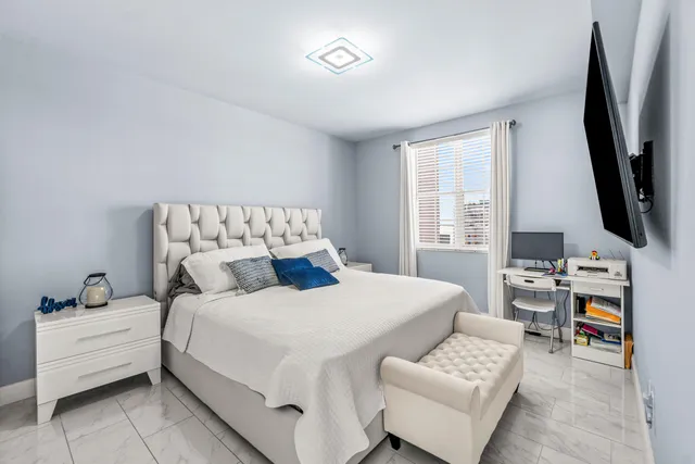 a bedroom with a bed and a flat screen tv