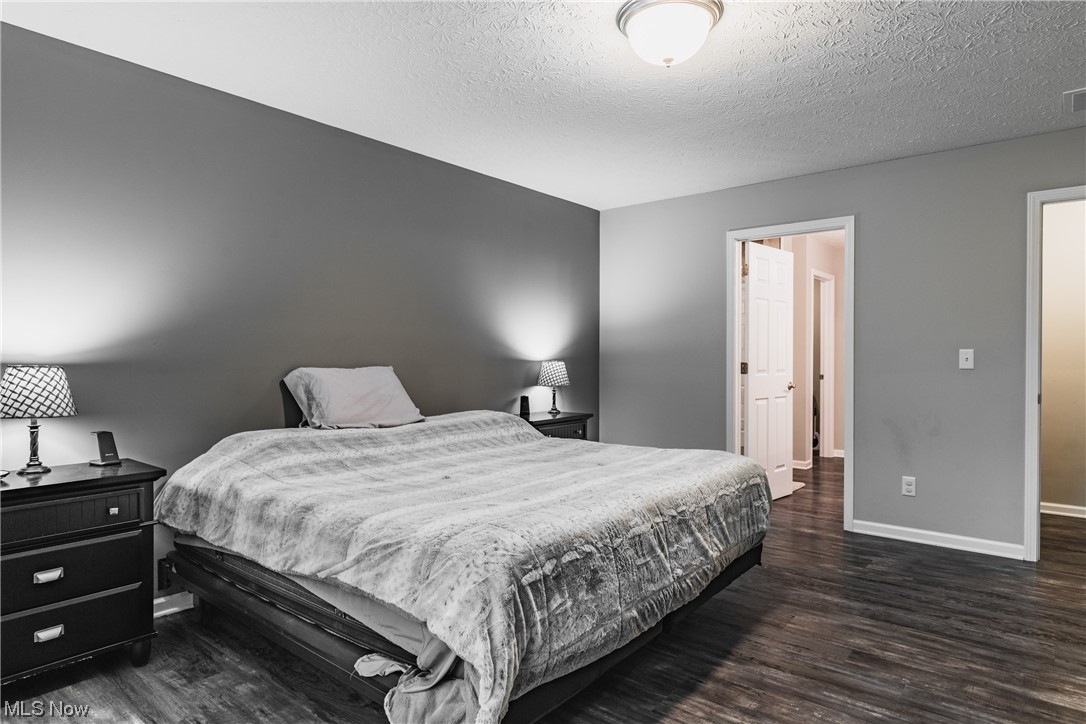 2545 Layman Road Vincent, OH 45784 - Photo 12 of 32 Bedroom featuring dark hardwood flooring and a textured ceiling