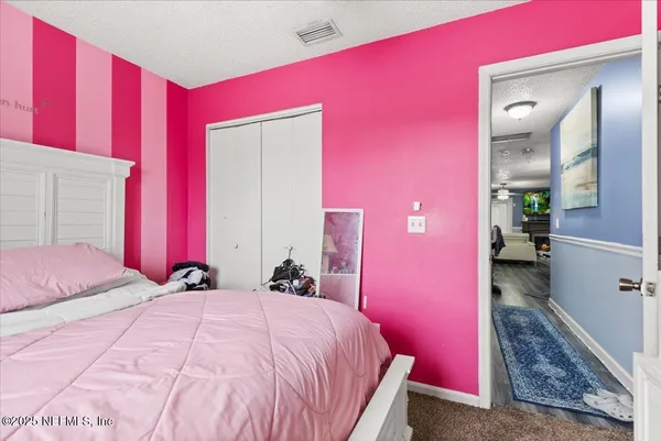 a bed room with a bed and a dresser