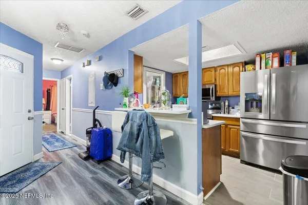 a kitchen with stainless steel appliances granite countertop a refrigerator and a stove