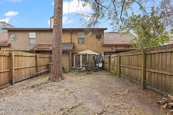 a view of a house with wooden fence