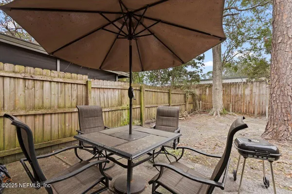 a patio with a patio table and chairs