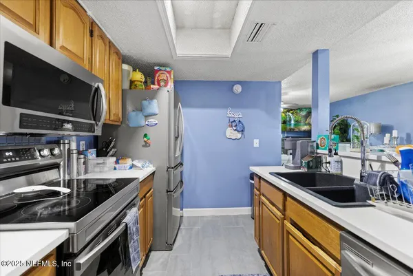 a kitchen that has a sink and a stove in it