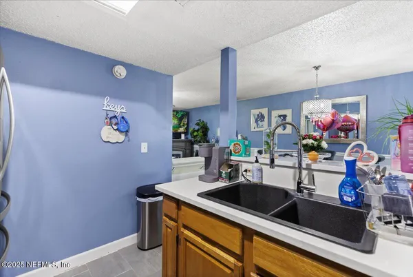 a kitchen with a sink cabinets and a potted plant