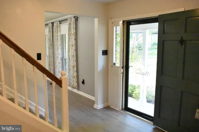 a bathroom with a granite countertop sink and a window