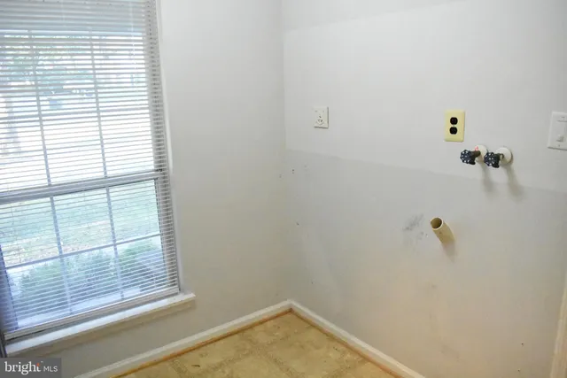 a view of an empty room with a kitchen