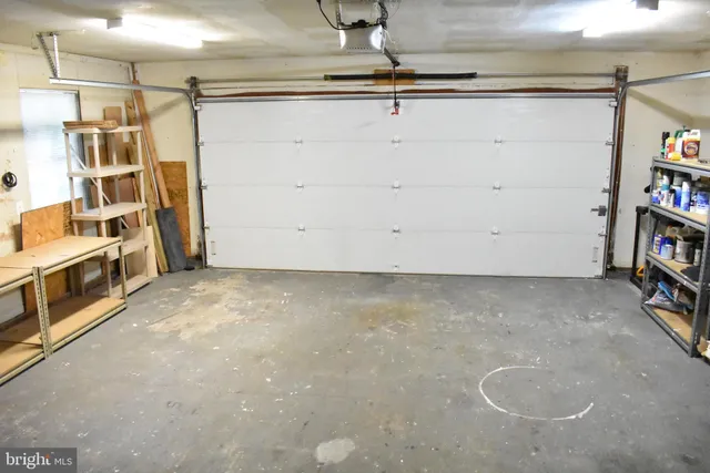 a view of staircase with railing and white walls