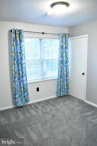 a view of closet with wooden floor