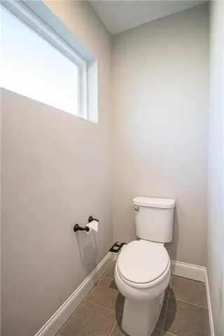 a white toilet sitting next to a white sink