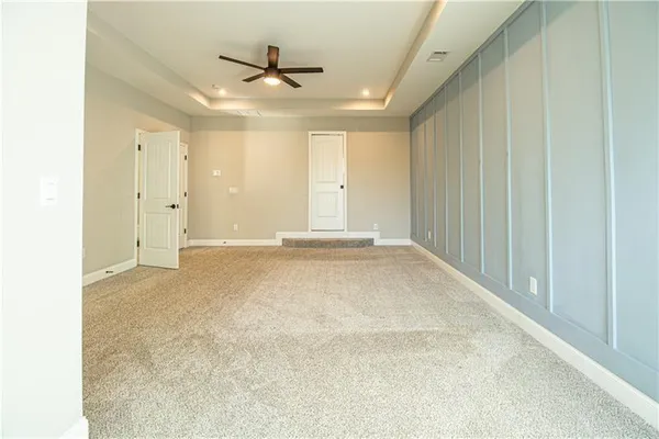 a view of a livingroom with a ceiling fan and window