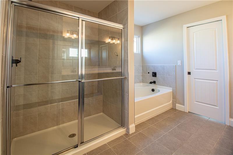 7950 Welch Mill Ball Ground, GA 30107 - Photo 17 of 32 a bathroom with a bathtub and a shower