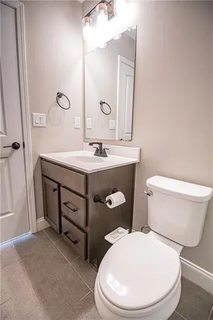 a bathroom with a toilet a sink and mirror