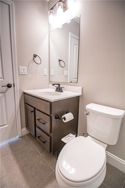 7950 Welch Mill Ball Ground, GA 30107 - Photo 19 of 32 a bathroom with a toilet a sink and mirror